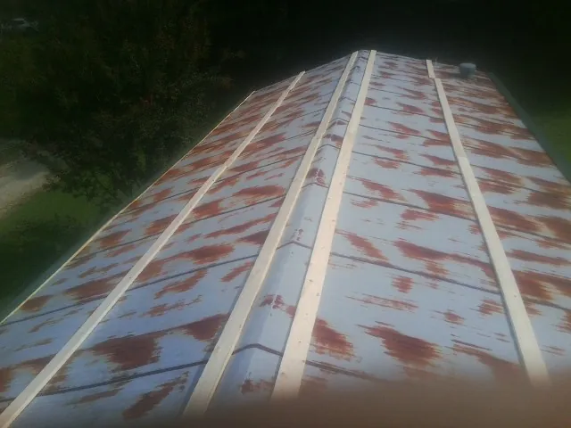 Rusted metal roof panels with new wood purlins before replacement — Storm Damage Roof Repair in Hannaford by Roofing Brothers