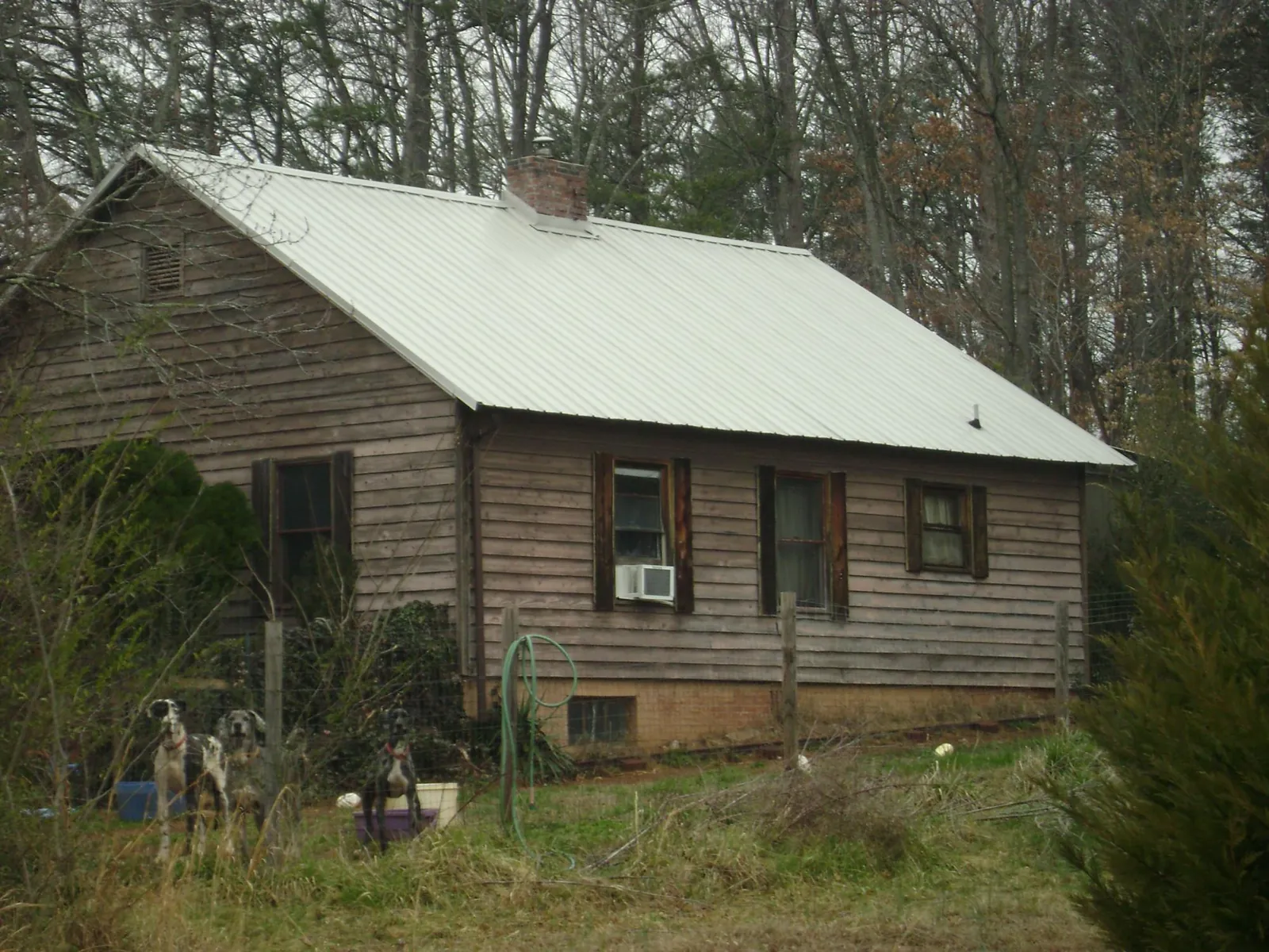 White metal roof on an old wood sided farmhouse, from a Metal Roof Installation job in Hannaford